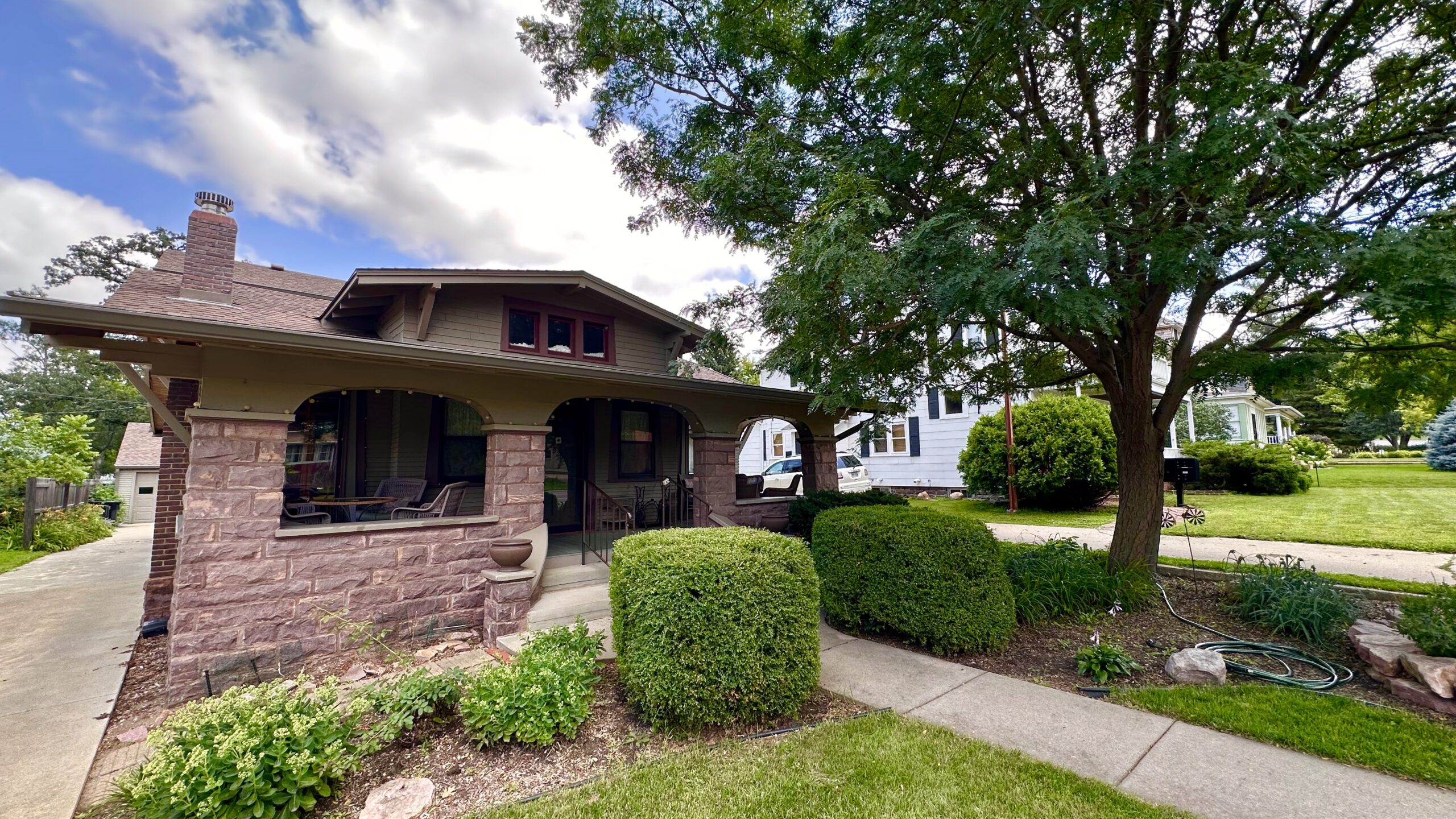 A wide angle of the front exterior elevation and garden.